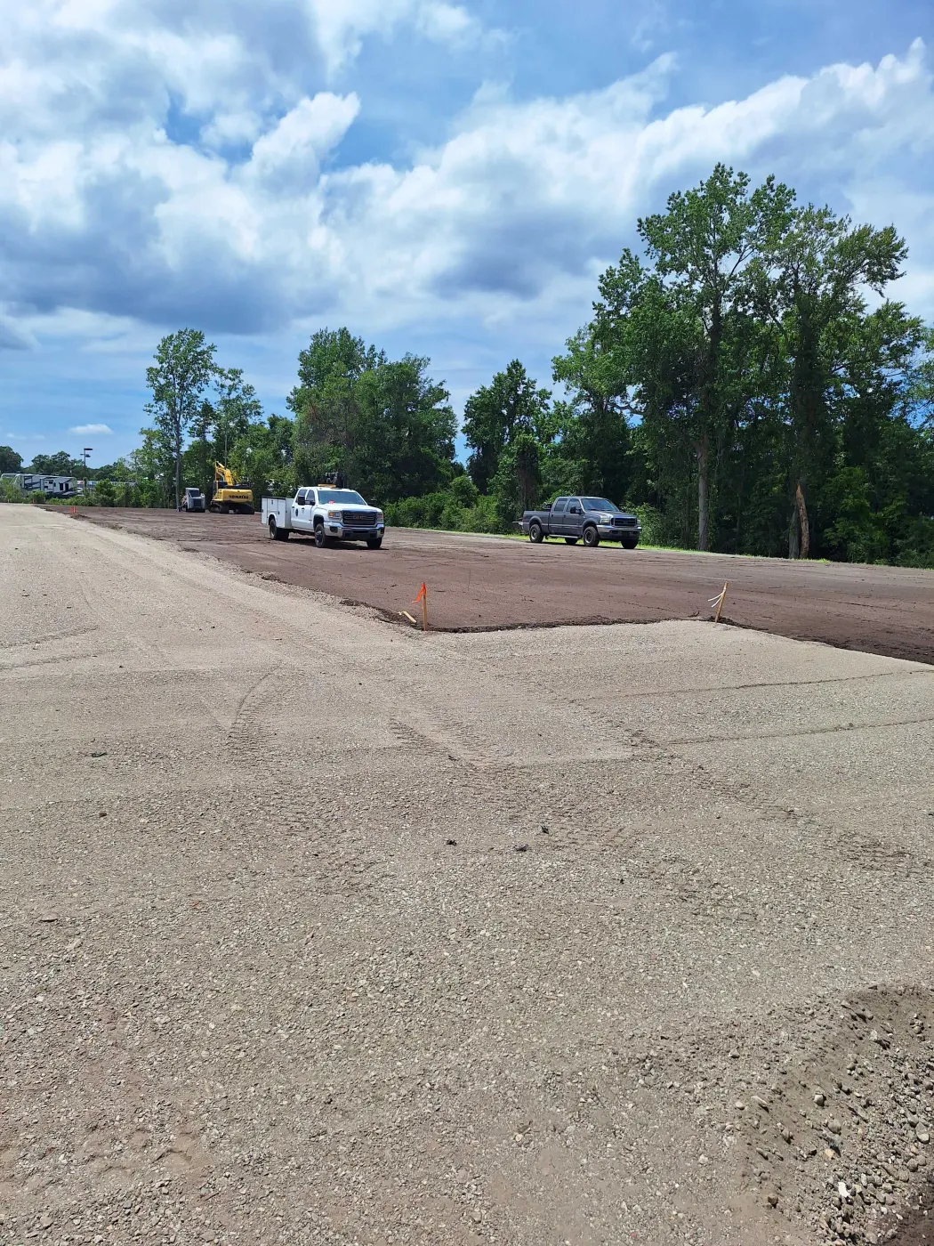 Wide gravel pad with stone spread level and erosion matting along one edge near Burgaw, NC
